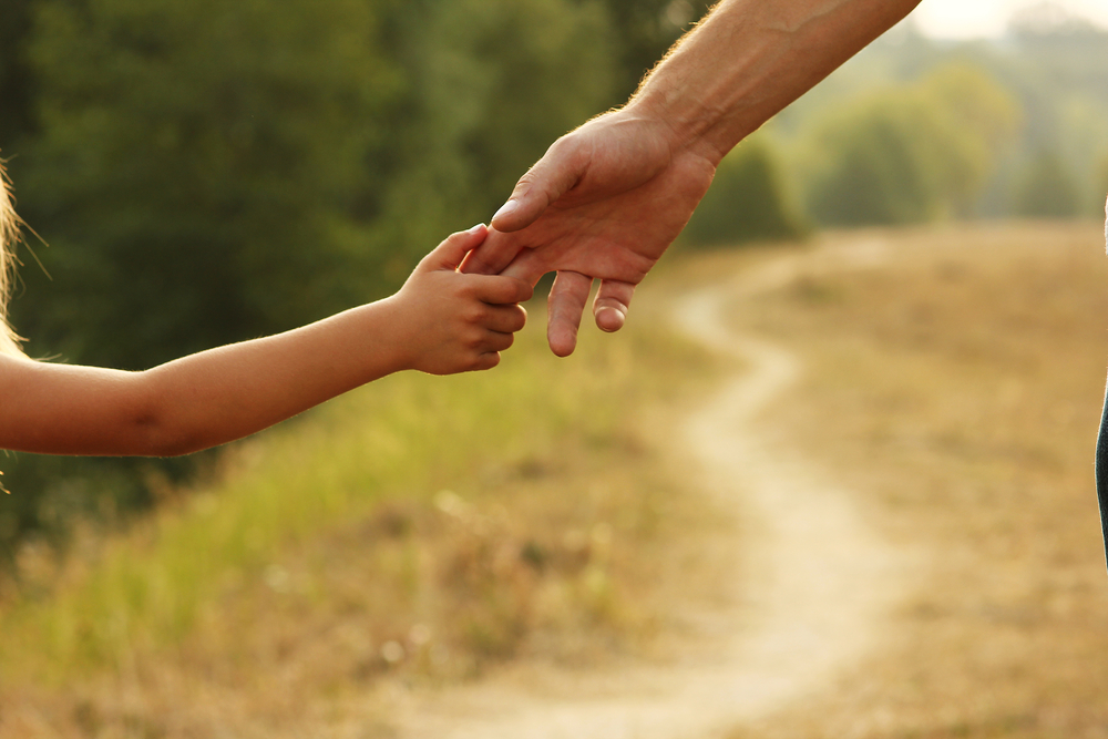 Family Law - the parent holds the hand of a small child
