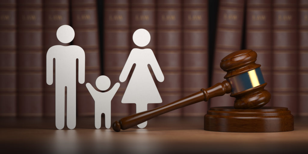 Family law. Gavel and shapes of men, women and child with books