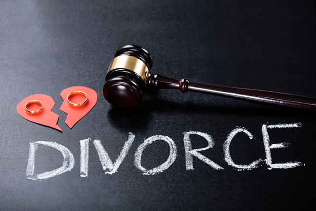 Gavel on chalkboard with broken hearts and wedding bands in each half of the heart over the word written chalk "divorce" of a High Net Worth Divorce Attorney Tampa FL